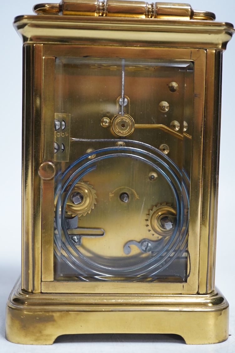 An early 20th century brass repeating carriage clock with key, 13cm. Condition - fair to good, not tested as working